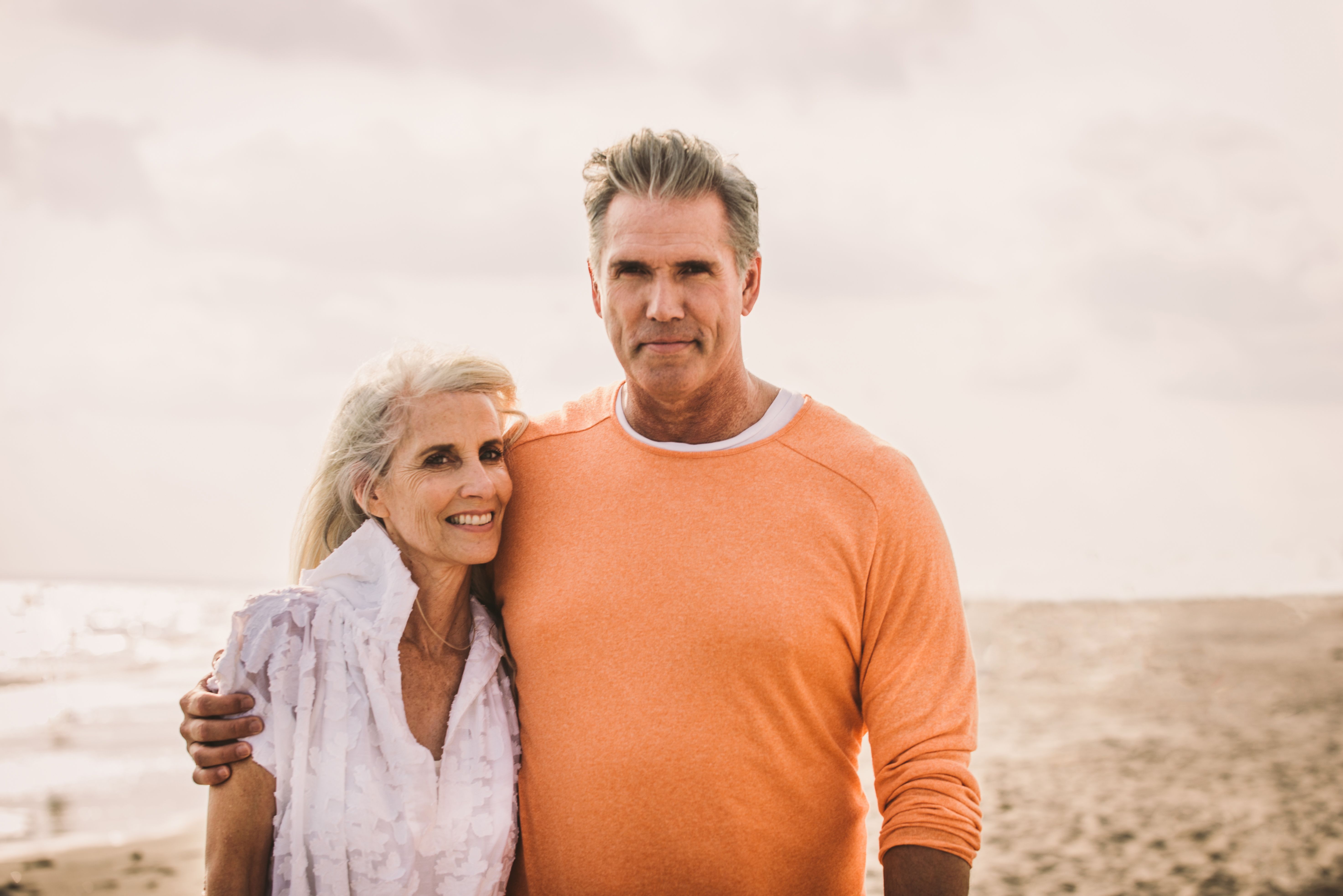 A senior couple enjoying a romantic outdoor moment during their luxury RV adventure, embracing comfort and nature.